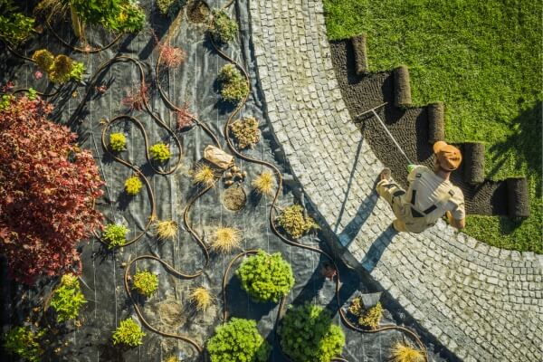 Aerial view of a landscaped garden with stone paving, curved beds and structured planting
