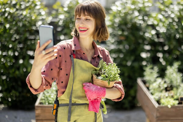 Garden designer meeting a homeowner outdoors, discussing ideas during an initial garden design consultation