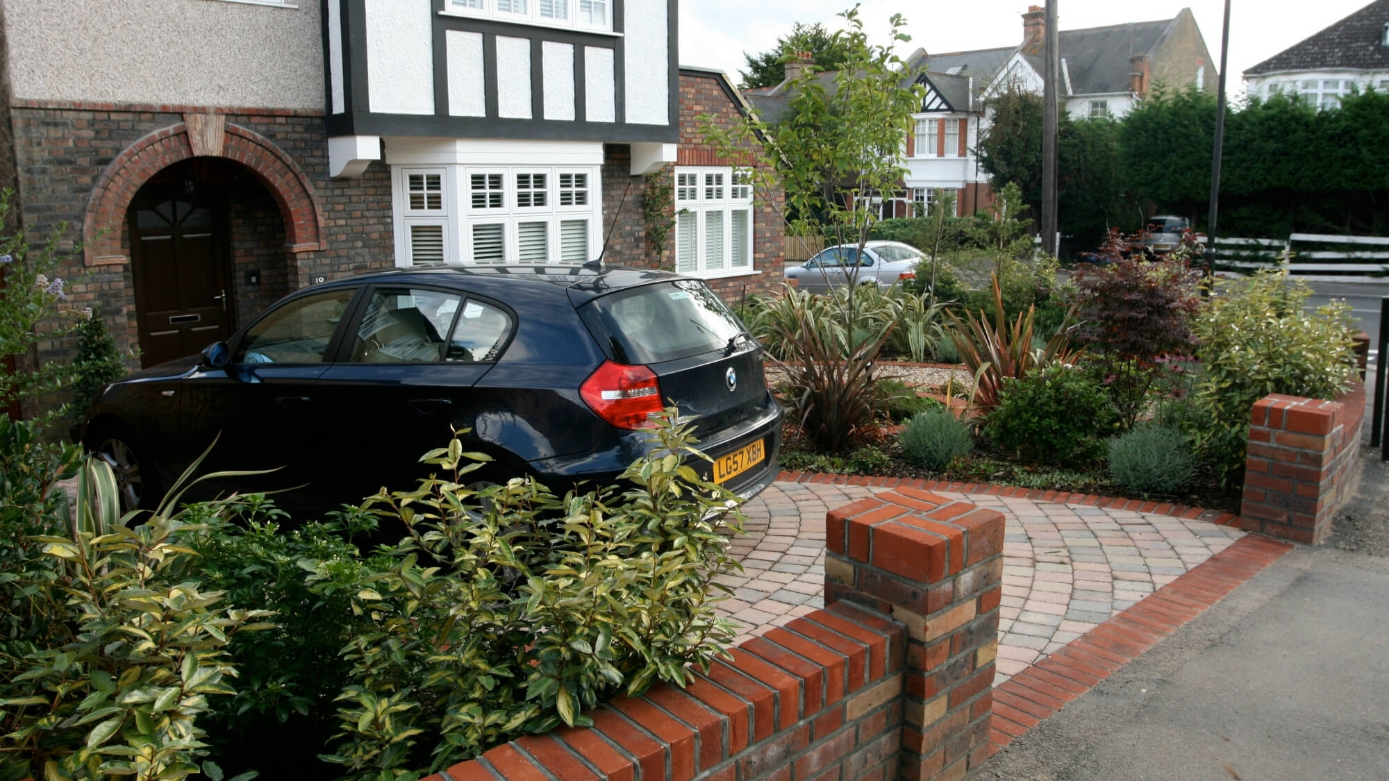 front garden design with driveway paving and planting borders