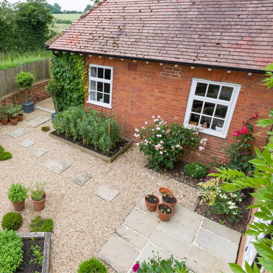 practical garden design in Sutton with patio, gravel, stepping stone paths and edible planting beds