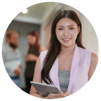 Smiling woman holding a tablet in an office environment.