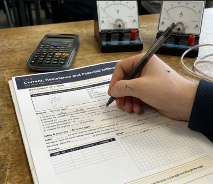 A Physics With Kate practice workbook being filled in