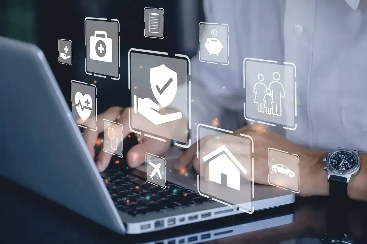 Icônes de protection et sécurité au-dessus d’un ordinateur, représentant les solutions d’assurance et de prévoyance proposées par un conseiller en gestion de patrimoine à Lyon.