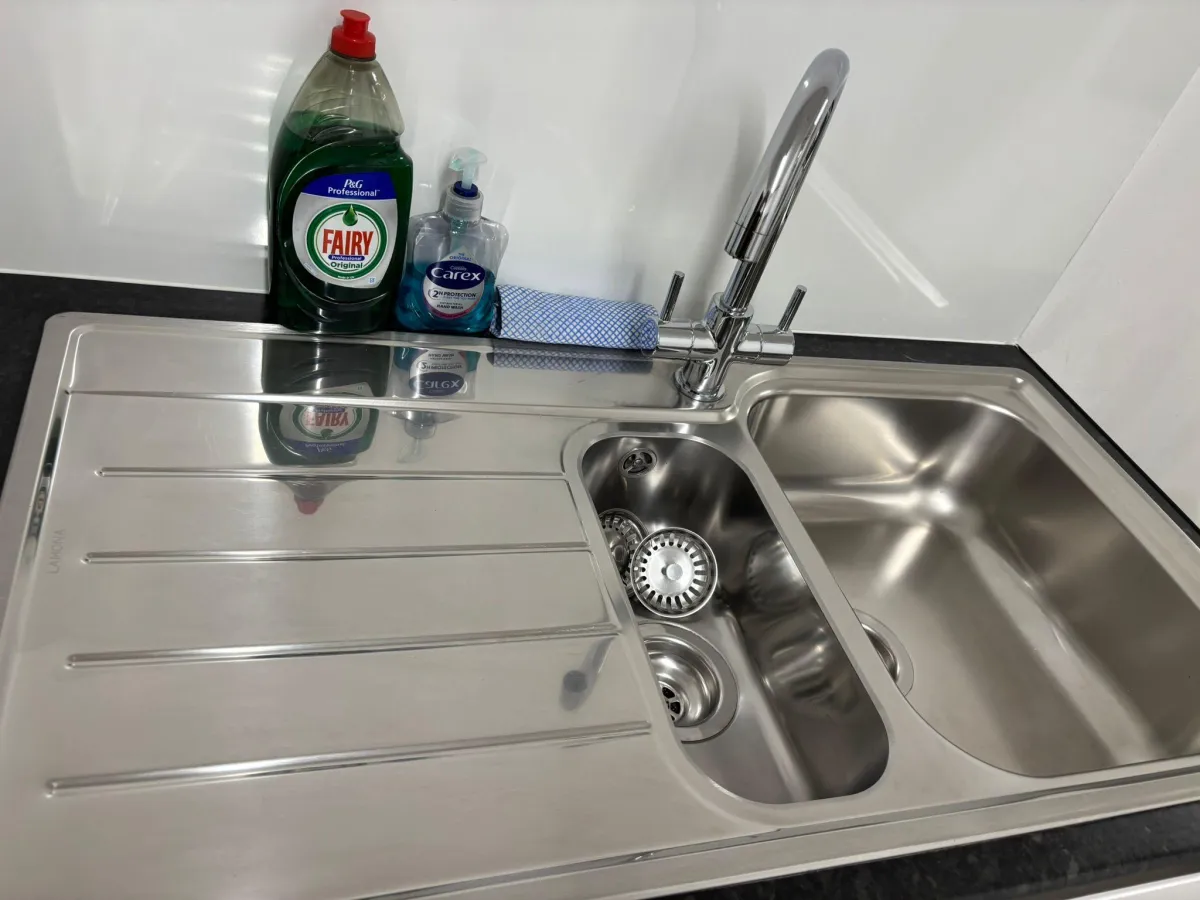 Polished stainless steel kitchen sink after a clean