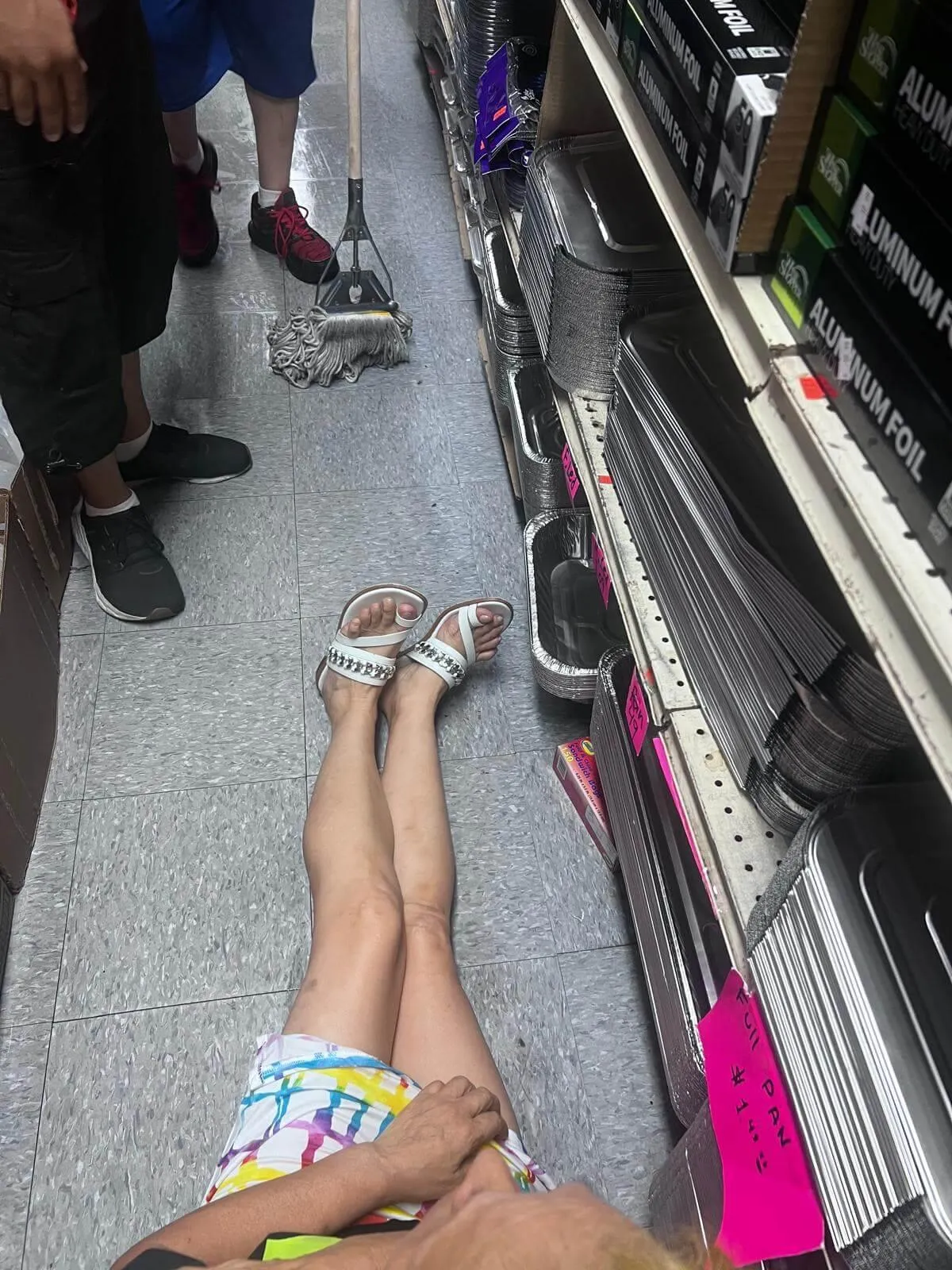 A woman lying on the floor after a slip and fall accident in a store, highlighting the dangers of unsafe conditions and wet floors. Our Bronx slip and fall lawyers help victims seek compensation for injuries caused by negligent store owners and property managers