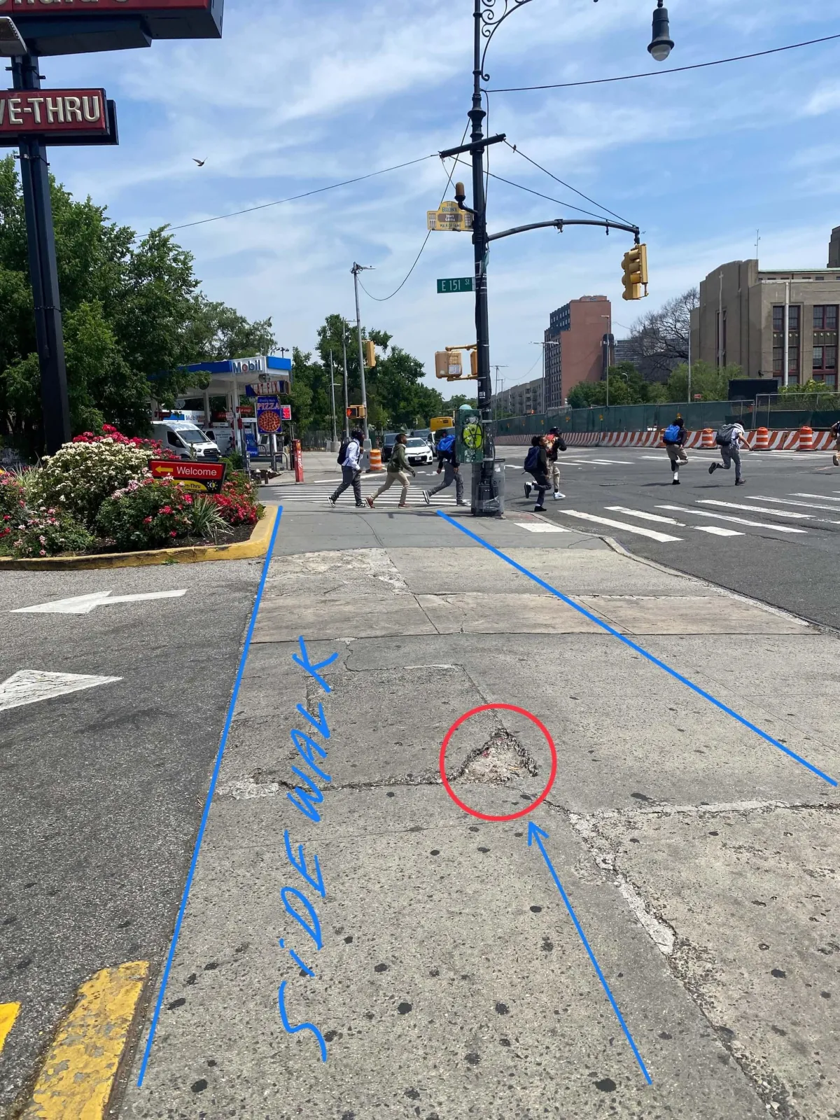 A cracked and damaged sidewalk highlighted by an investigator in front of a Bronx McDonald’s, showing a hazardous defect that poses a serious trip and fall risk. Our Bronx personal injury lawyers help victims seek compensation for injuries caused by unsafe sidewalks and negligent property maintenance