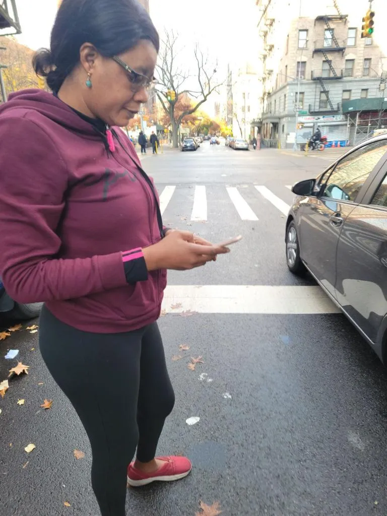 A client receiving a case update on her cell phone from her Bronx personal injury lawyer, ensuring clear communication and transparency throughout the legal process. Our law firm keeps clients informed every step of the way