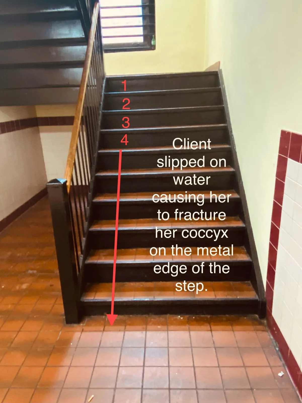 A stairwell in a Bronx building with investigator markup showing where our client slipped on water and suffered injuries. Our Bronx slip and fall lawyers help victims seek compensation for hazardous stairway conditions and property negligence.