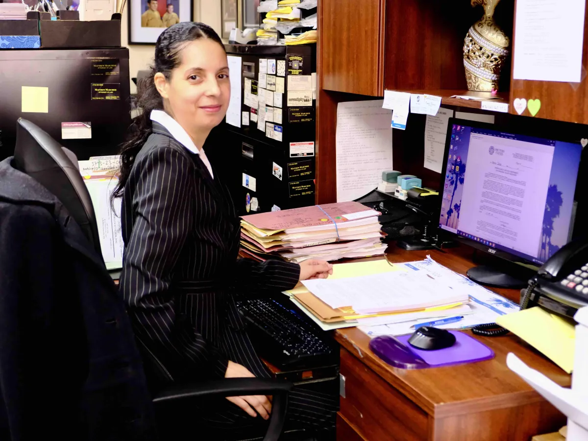 Bronx injury lawyer with client smiling outside office on East Tremont Avenue