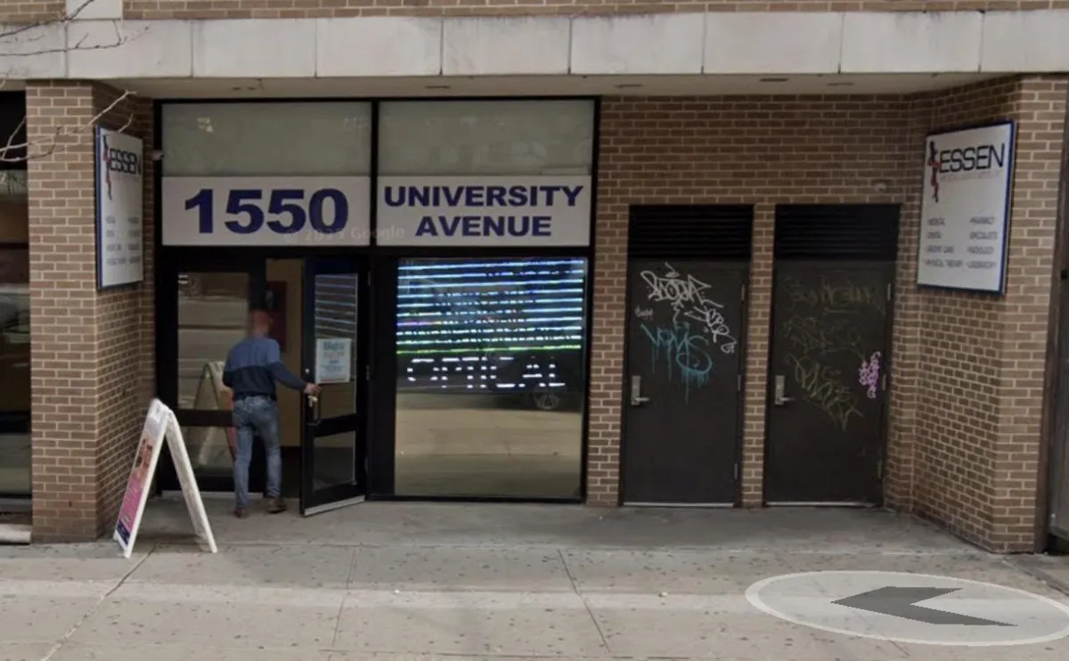 Front entrance of Essen Urgent Care — 1550 University Avenue, Bronx, with pedestrian entering and sandwich board on sidewalk.