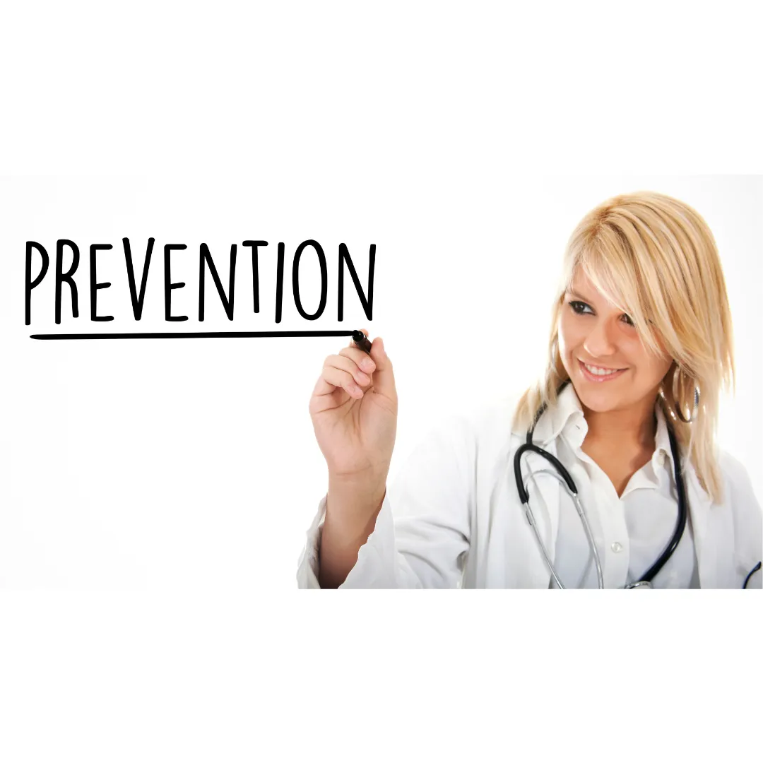 Female doctor smiling while writing “Prevention” on a transparent board, emphasizing proactive healthcare.
