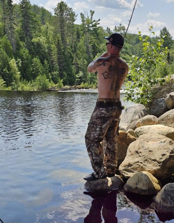 Chief Little Eagle fishing in freshwater lake.