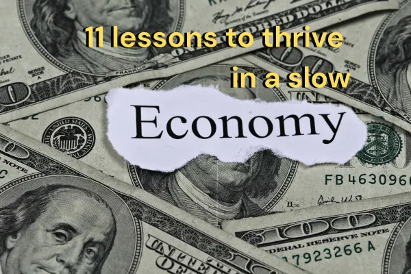 11 lessons to thrive in a slow economy text with an image of money in the background