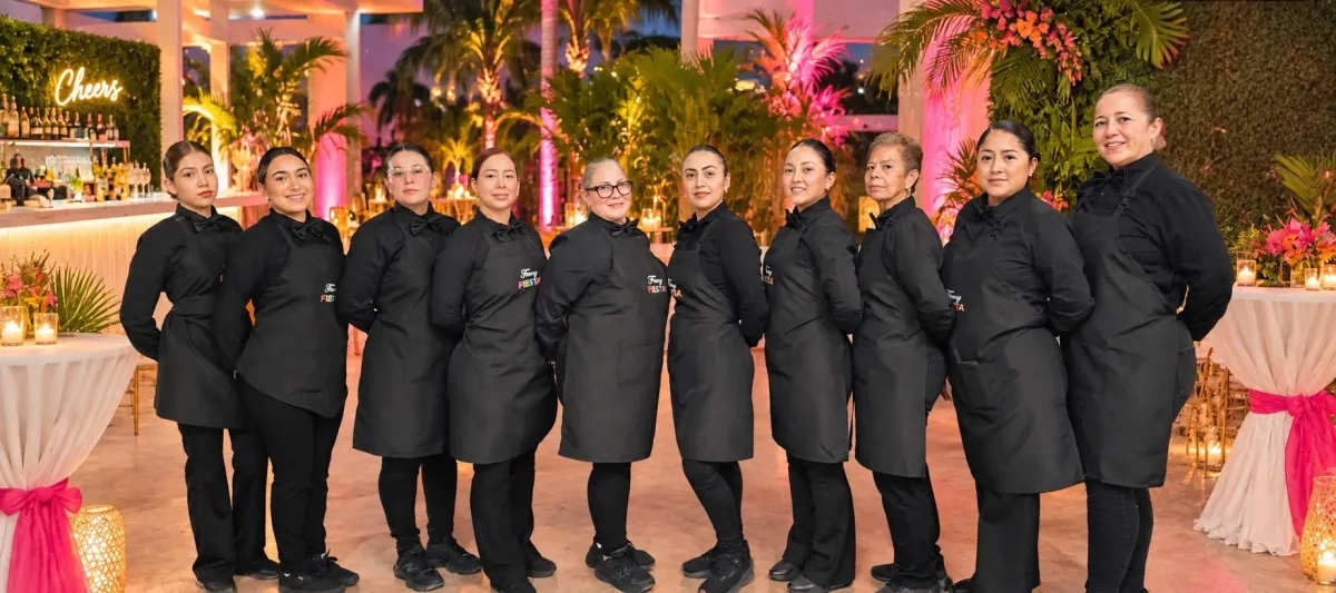 Fancy Fiesta® professional event staff in black uniforms at an upscale Miami event venue with tropical décor and elegant event styling.