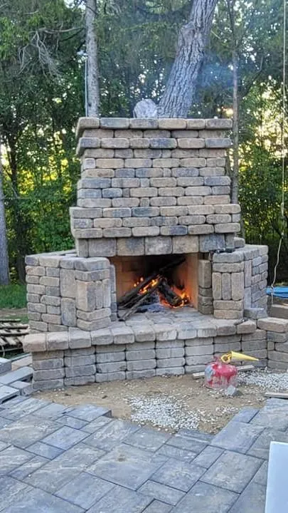 Stylish outdoor fireplace by All Service Specialists - Enhance your outdoor living space with a beautifully crafted fireplace, perfect for cozy evenings and entertaining guests.