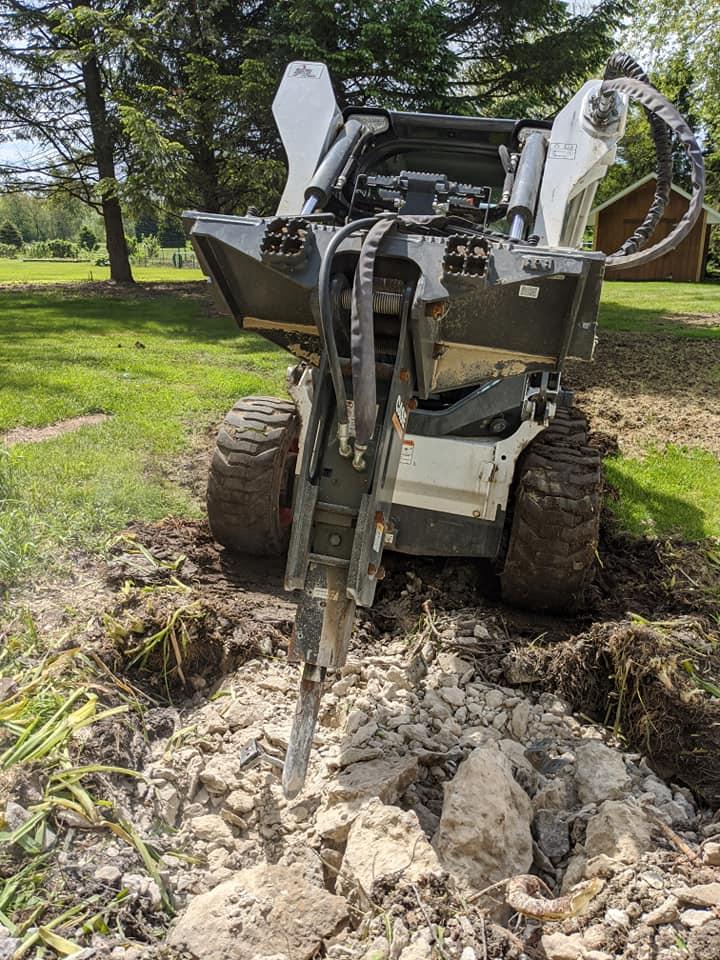 Skid steer loader in action - versatile construction equipment used for various tasks in landscaping and construction projects.