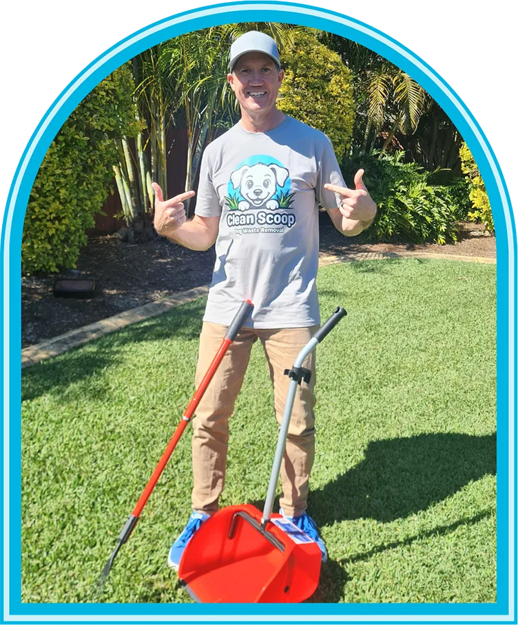 Dan from Clean Scoop standing on a lawn, smiling and pointing at his Clean Scoop shirt, holding pet waste removal tools in a sunny backyard.