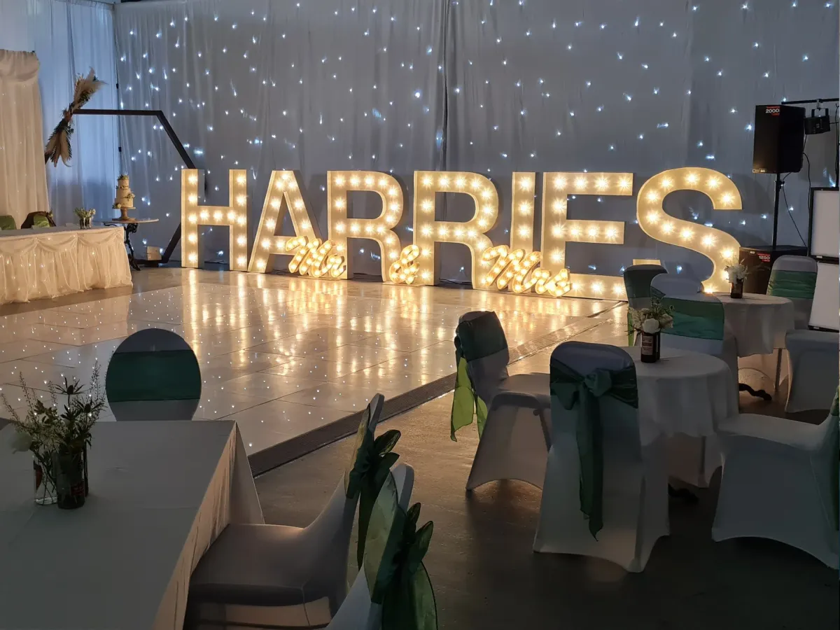 LED starlit dance floor with illuminated letters and props.