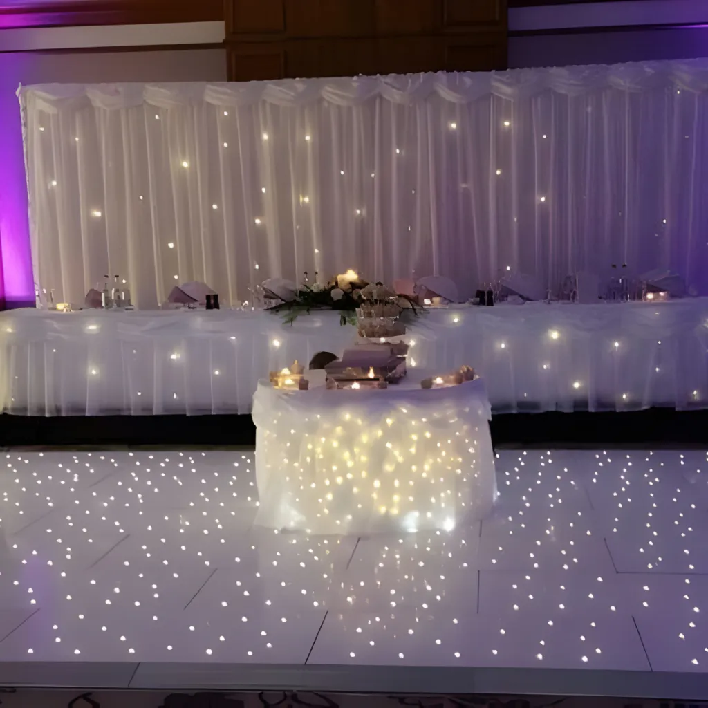 Beautifully dressed wedding venue with white draping and gold accents