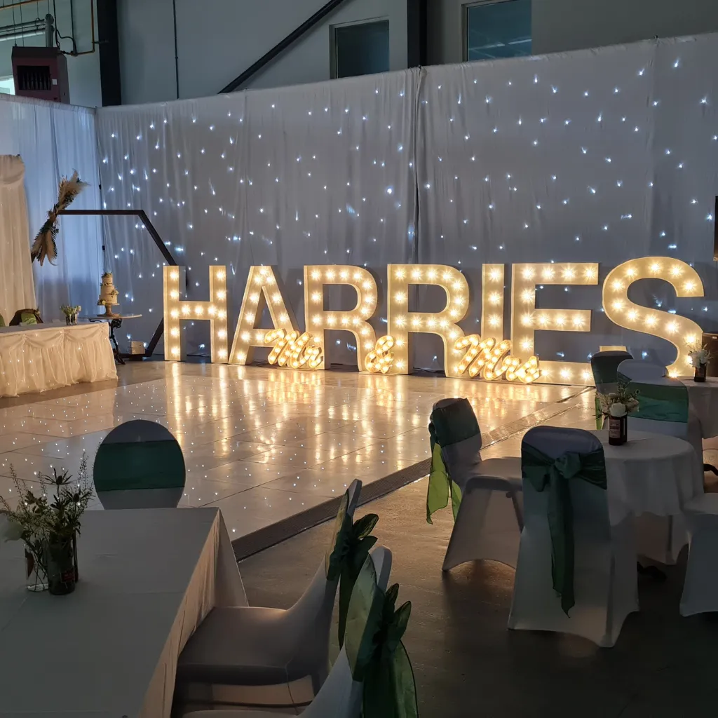 Beautifully dressed wedding venue with white draping and gold accents