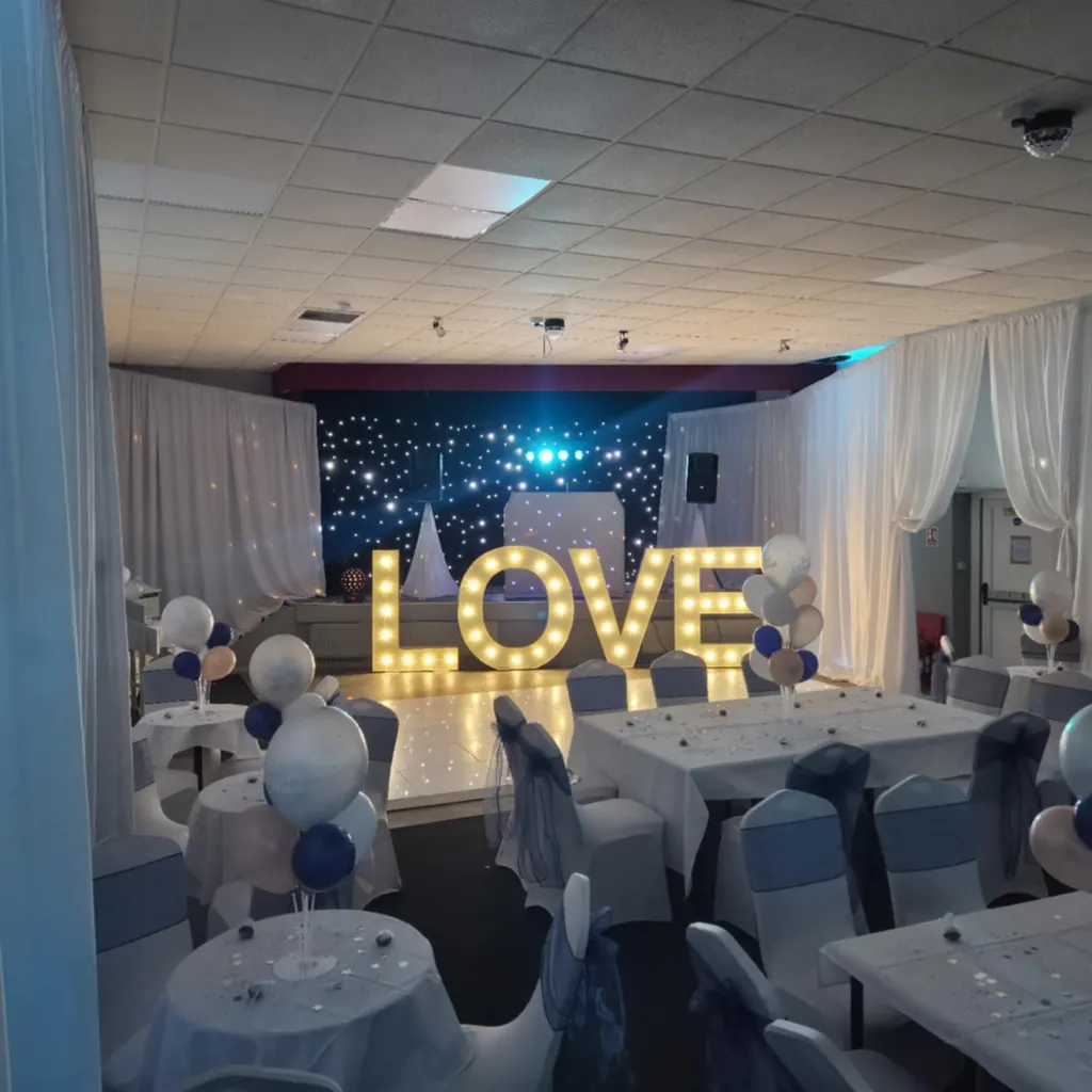 Beautifully dressed wedding venue with white draping and gold accents