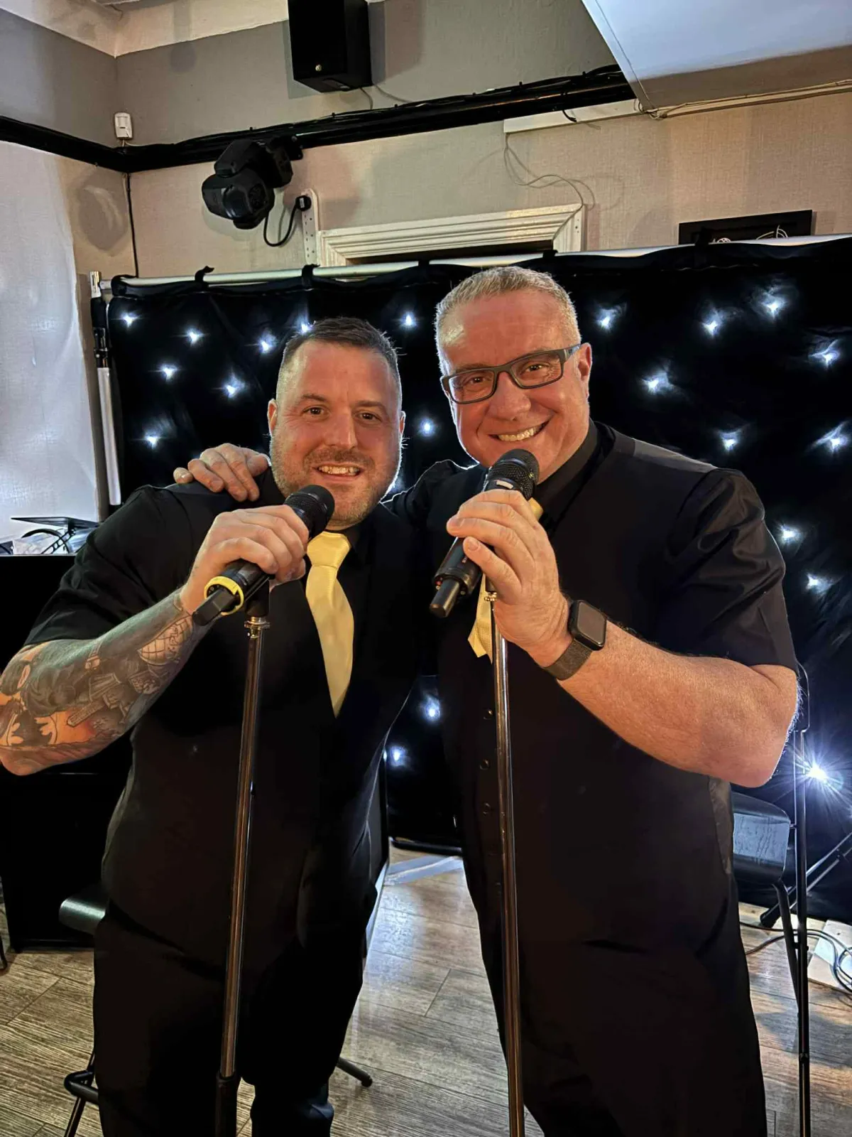 Guests taking fun photos in a magic mirror selfie booth at an event
