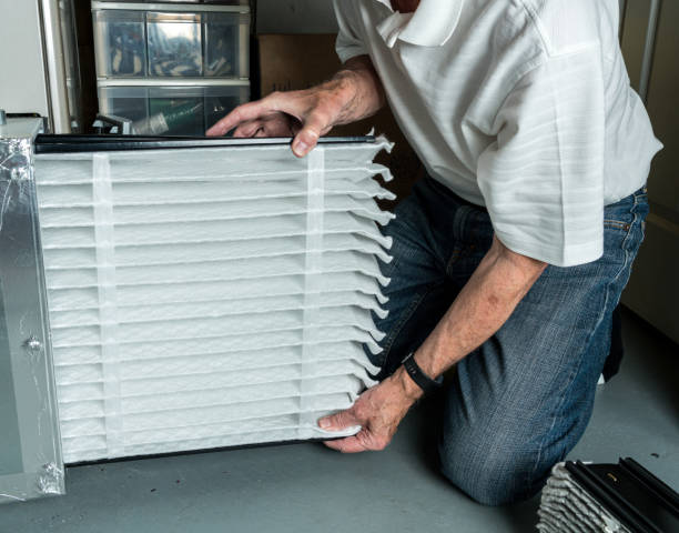 Installing upgraded high efficiency HVAC air filter to improve indoor air quality