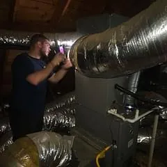 technician inspecting hvac ductwork during indoor air quality inspection in memphis tn
