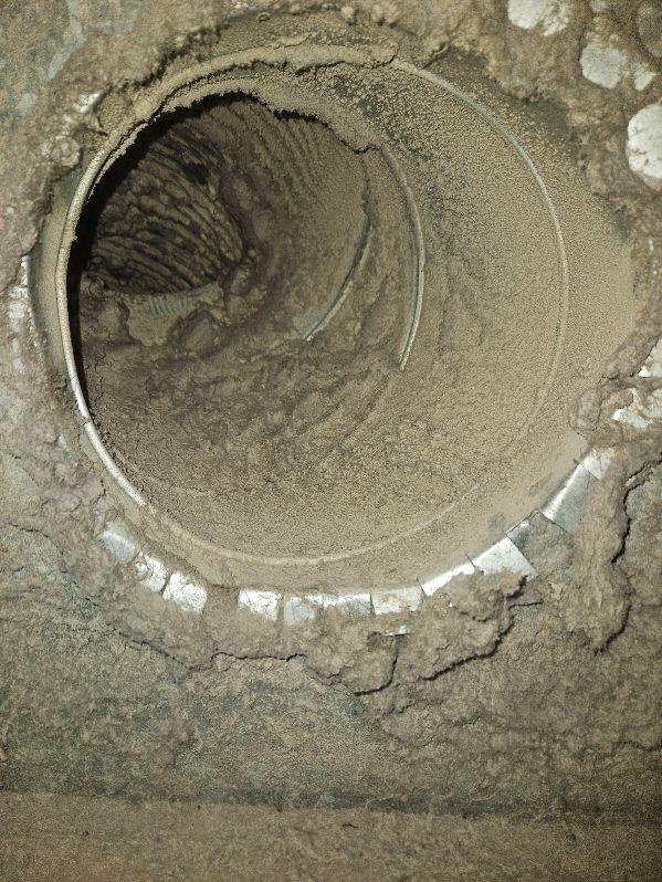 Heavy dust accumulation inside HVAC ductwork indicating need for duct cleaning