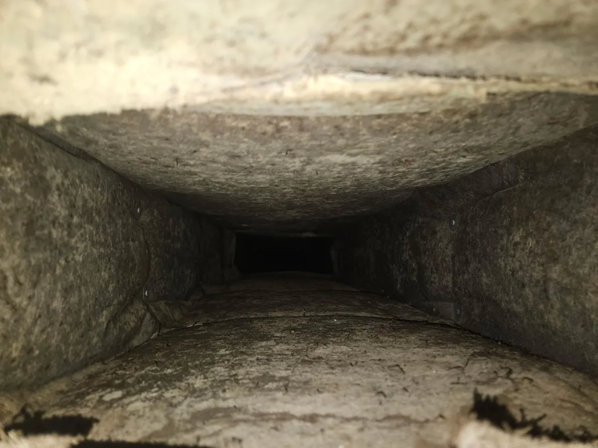Dust and contamination buildup inside residential HVAC ductwork affecting indoor air quality