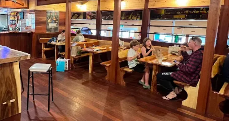 Families and children sitting together at tables in the cafe area, enjoying a meal.