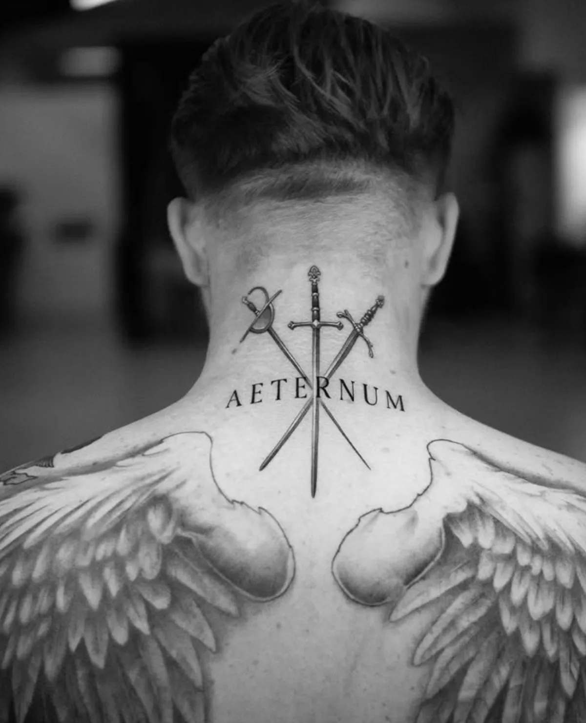 person in blue denim shorts and white nike sneakers standing on gray concrete floor