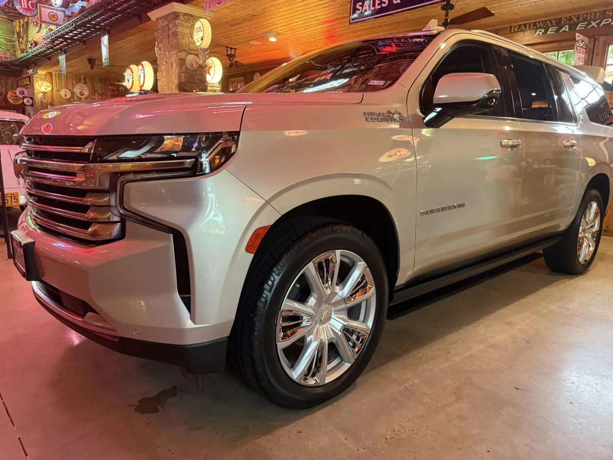 Freshly detailed silver Chevy Suburban in a collector's garage