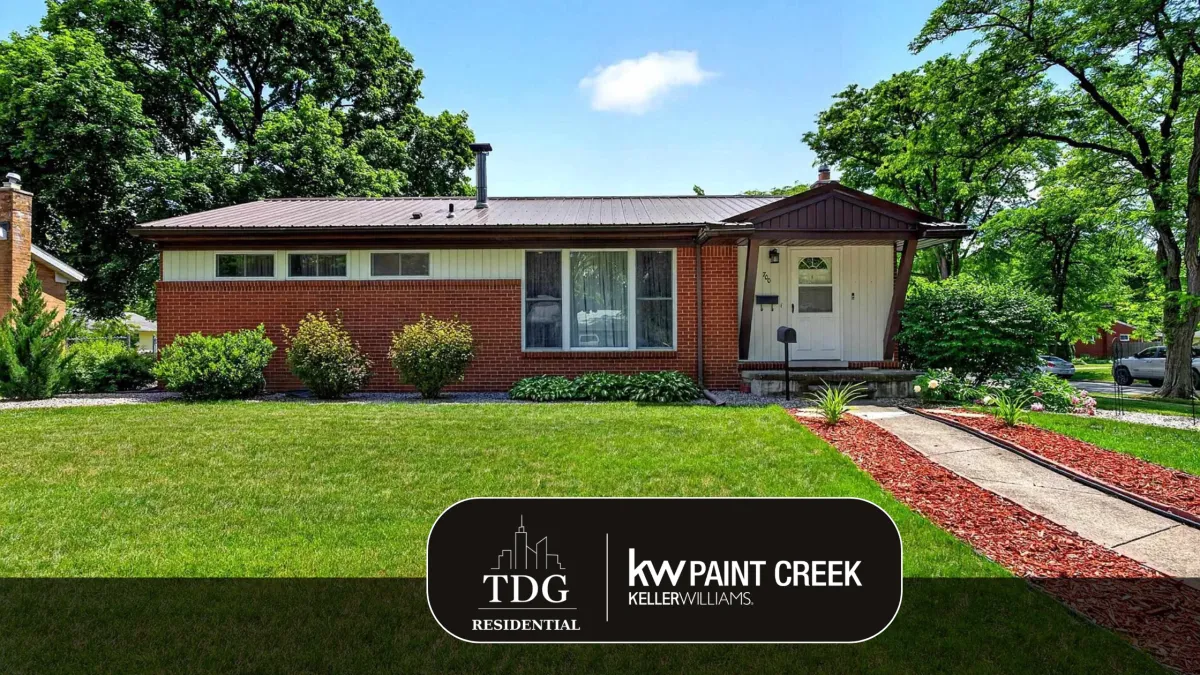 Turnkey brick ranch for sale at 700 Coolidge Dr, Midland, MI 48642 with a fenced backyard, deck, and detached garage, listed by The Delia Group.
