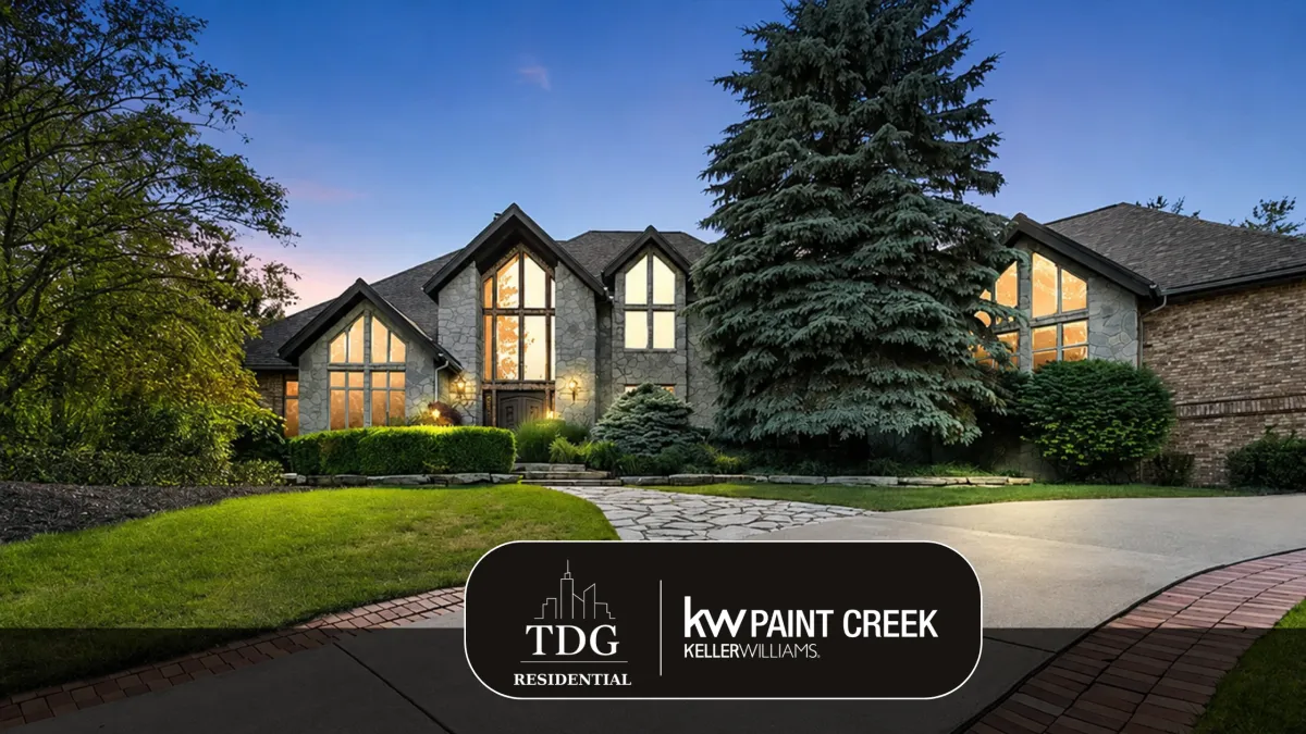 Custom luxury estate for sale at 6263 Canter Creek Trl, Grand Blanc, MI 48439 in Pine Hollow Estates with panoramic pond views, listed by The Delia Group.