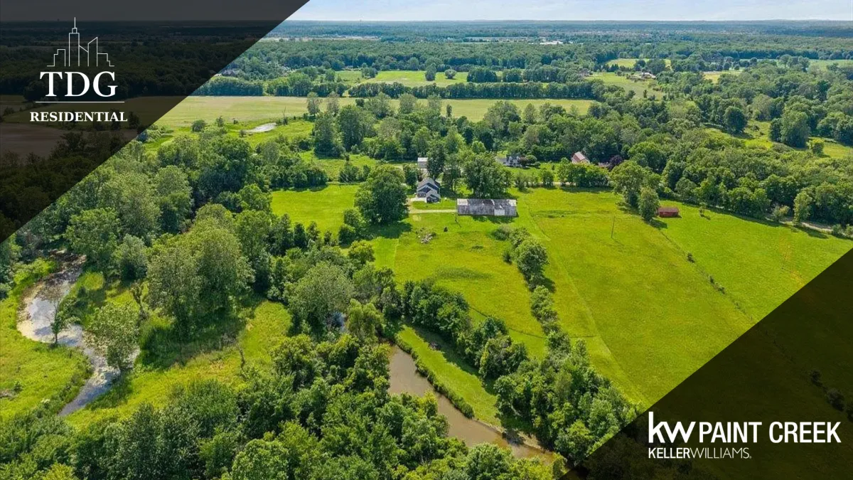 34+ acre property for sale at 54230 Card Rd, Macomb, MI 48042 in Macomb Township with a custom home and large Gambrel-style barn, listed by The Delia Group.
