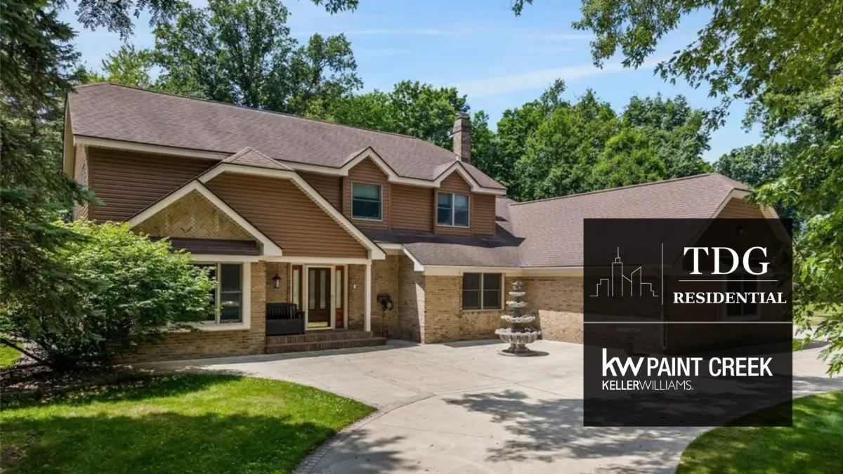 Spacious 2-acre home for sale at 5408 Coral Ridge Dr, Grand Blanc, MI 48439 in Warwick Hills with a saltwater pool and bonus building, listed by The Delia Group.