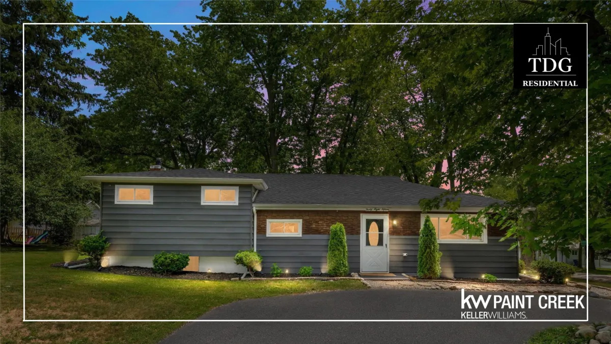Beautifully updated home for sale at 3815 Edgecrest St, West Bloomfield Twp, MI 48324 with a stunning kitchen and covered porch over a tree-lined backyard, listed by The Delia Group.