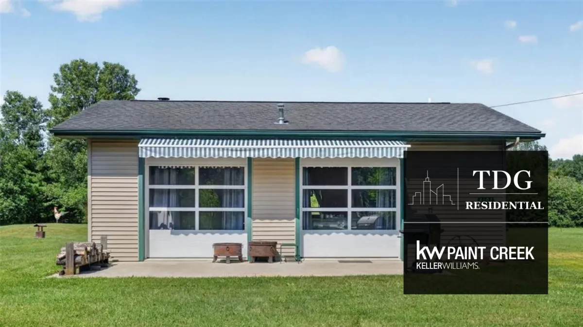 Turn-key Northern Michigan retreat for sale at 4107 Pine St, Gladwin, MI 48624 on 4.5 wooded acres with a knotty pine cabin and barn, listed by The Delia Group.