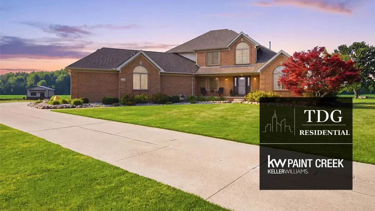 All-brick Richmond MI estate at 30738 School Section Rd with more than six acres, pond views, a finished three-car garage, and a heated pole barn.