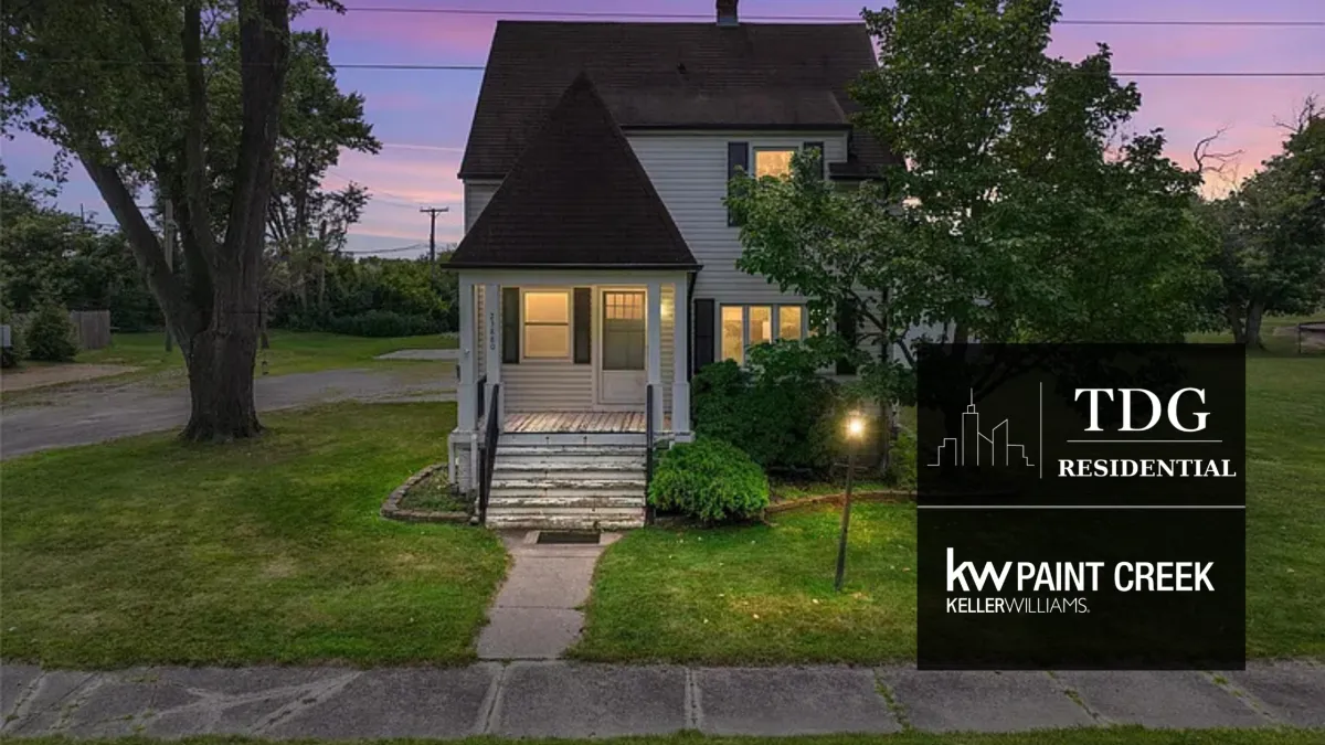 Clinton Township Michigan home at 23880 Shook Rd with mature trees, matching outbuildings, concrete walkways, and expansive parking areas.