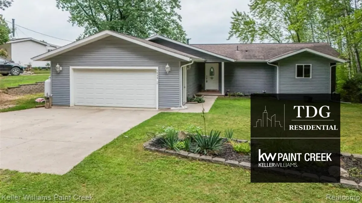 Chapman Lake waterfront ranch for sale at 5889 Raymond Dr, Gladwin Michigan 48624, with direct water frontage and dual outdoor decks, listed by The Delia Group.