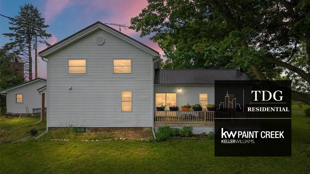 Fowlerville country home for sale at 8950 North Fowlerville Road with distinctive architecture, mature trees, and open green space, listed by The Delia Group.