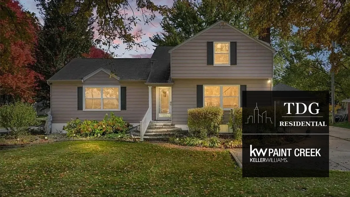 Exterior of the home at 6883 River Rd, Marine City, with a half-acre yard and large back deck, presented by The Delia Group.