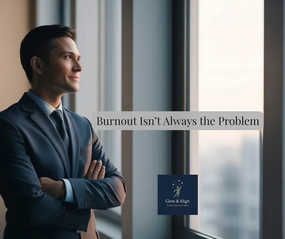 Leader sitting quietly looking out a window reflecting on burnout and leadership alignment.