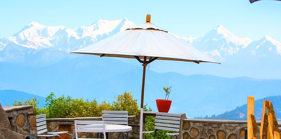 a breathtaking panoramic view of the snow-capped Himalayan mountain range under a clear blue sky