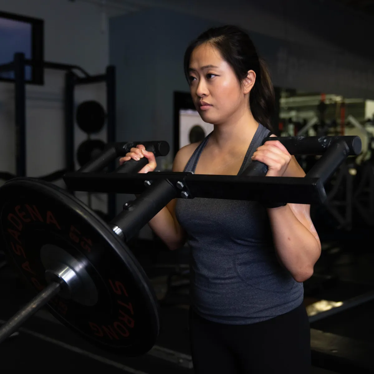 Female performing viking landmine presses in the gym