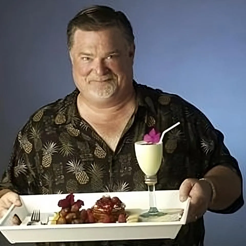 Happy Male physical therapy client holding a tray of food