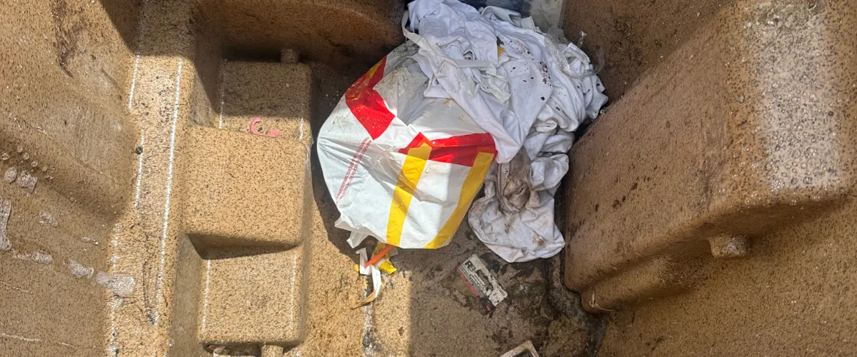 trash bin interior with trash and debris