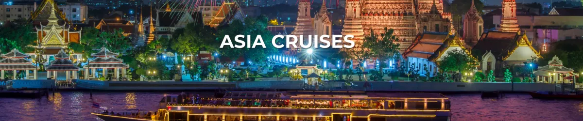 Night view of a brightly-lit luxury river cruise ship sailing past ornate temples and pagodas in Asia, with city lights in the background – Asia Cruises with Sassy Luxury Cruises